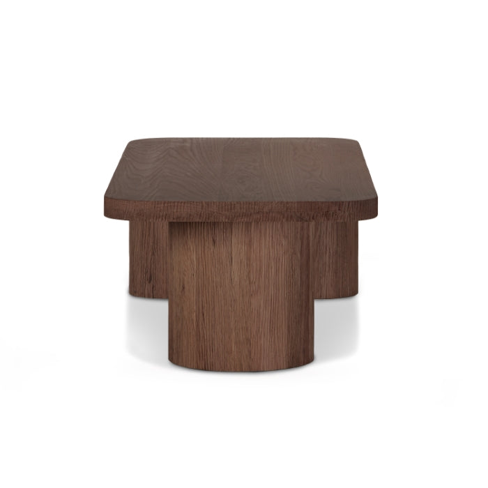 Table basse minimaliste en bois massif avec base monolithique pour salon